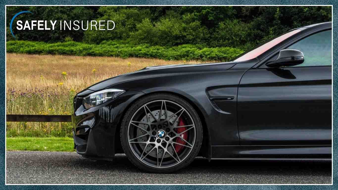 A picture of Tom's BMW M4 driving on a country road shot from the side on